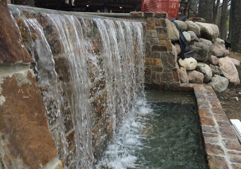 A waterfall that is built into the side of a building.